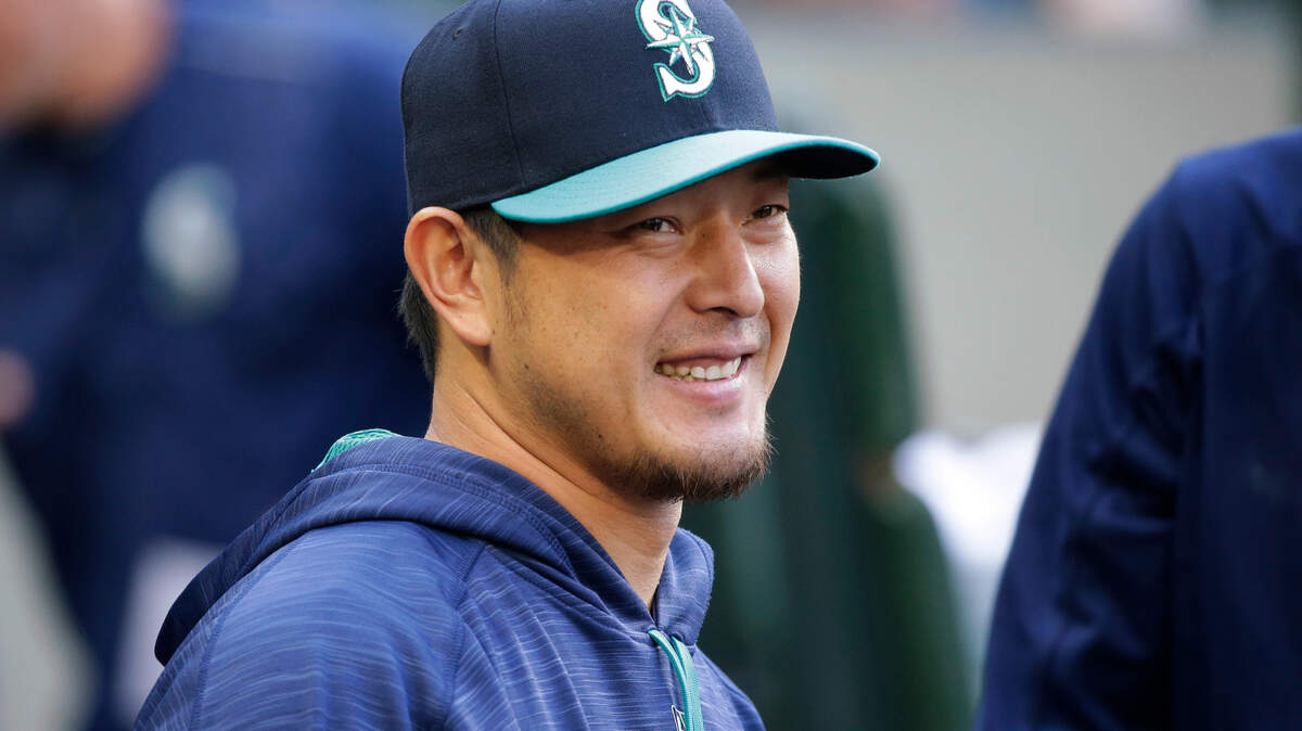 Seattle Mariners pitcher Hisashi Iwakuma smiles as he greets teammates in the dugout before the team’s baseball game against the Oakland Athletics, Friday, July 7, 2017, in Seattle. (AP Photo/Ted S. Warren)