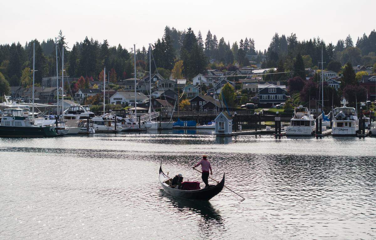 John Synco, owner of Gig Harbor Gondola rows his Venetian gondola, on Thursday, Oct. 9, 2025, in Gig Harbor, Wash. Synco just celebrated 10 years running the one-man gondola tour operation that he describes as a passion.