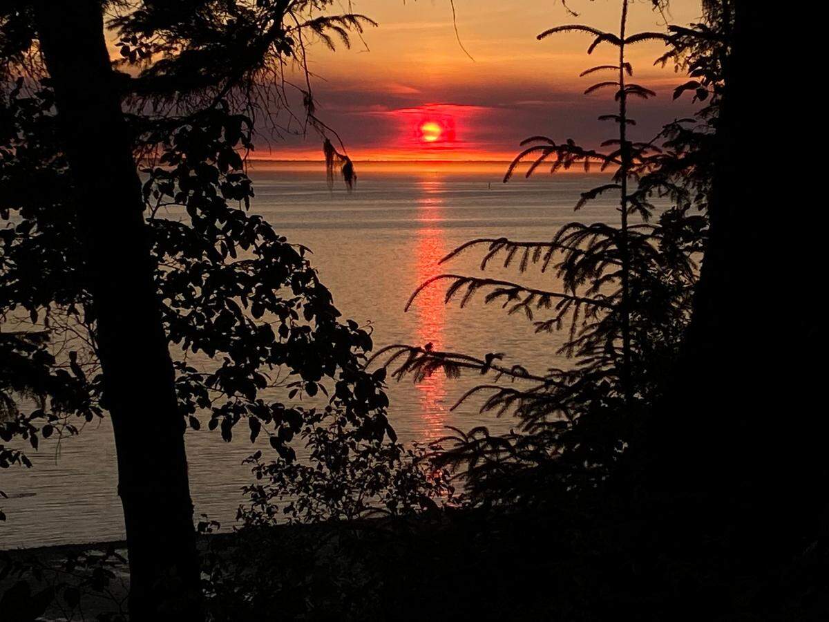 Wildfire smoke obscures the setting sun over Willapa Bay on June 26, 2022.