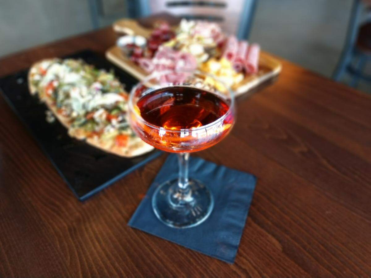 A negroni, charcuterie platter and flatbread from Glow Martini Lounge in Bonney Lake.