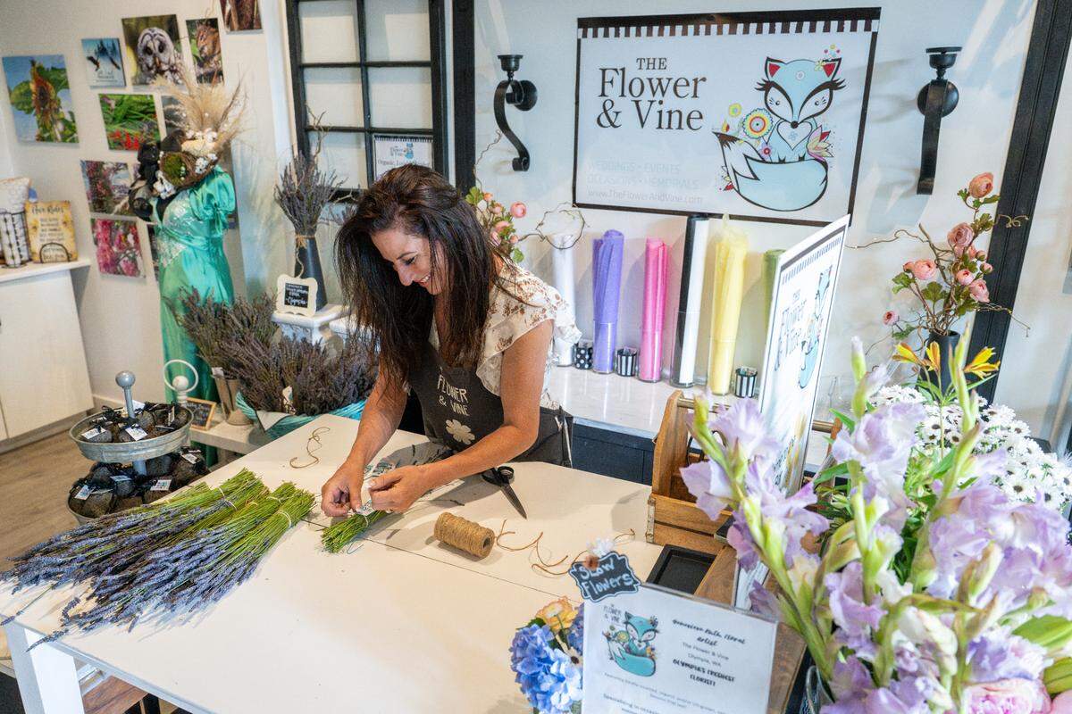 Genevieve Ruth, owner of The Flower & Vine, one of the permanent artisan partners at The Hive Market, prices lavender bunches on Wednesday, June 25, 2025, in DuPont, Wash.