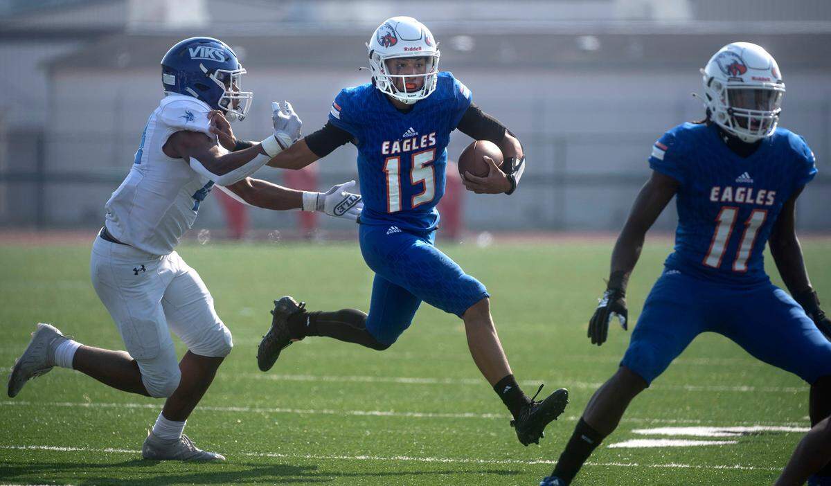 Graham-Kapowsin quaterback Daveon Superales tries to scramble away from Curtis linebacker Kane Able during Saturday’s football game at Art Crate Field in Spanaway, Washington, Oct. 8, 2022. Graham-Kapowsin won the game, 24-19.