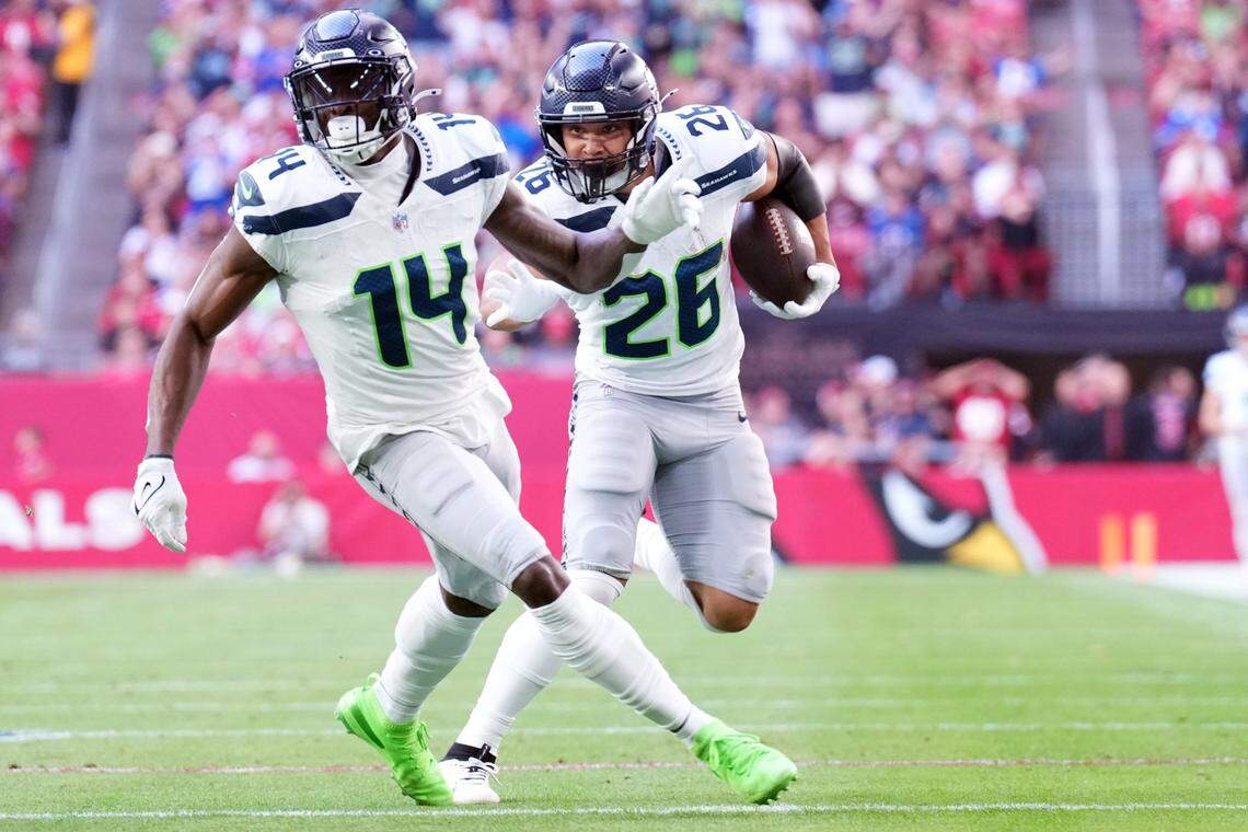 Seattle Seahawks running back Zach Charbonnet (26) follows the block of Seattle Seahawks wide receiver DK Metcalf (14) against the Arizona Cardinals during the first half at State Farm Stadium. Mandatory Credit: Joe Camporeale-Imagn Images