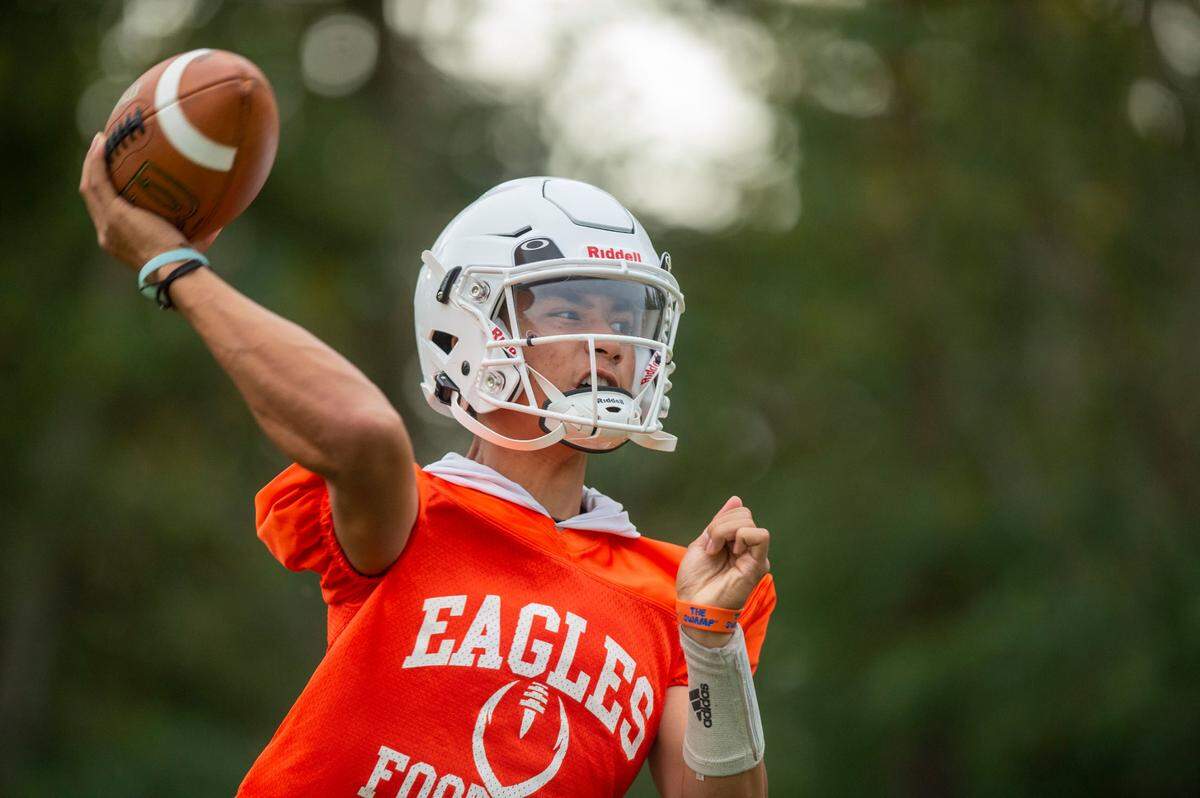 Graham-Kapowsin quarterback Daveon Superales winds up to throw a pass during drills on Thursday, Aug. 18, 2022, at Graham Kapowsin High School, in Graham, Wash.