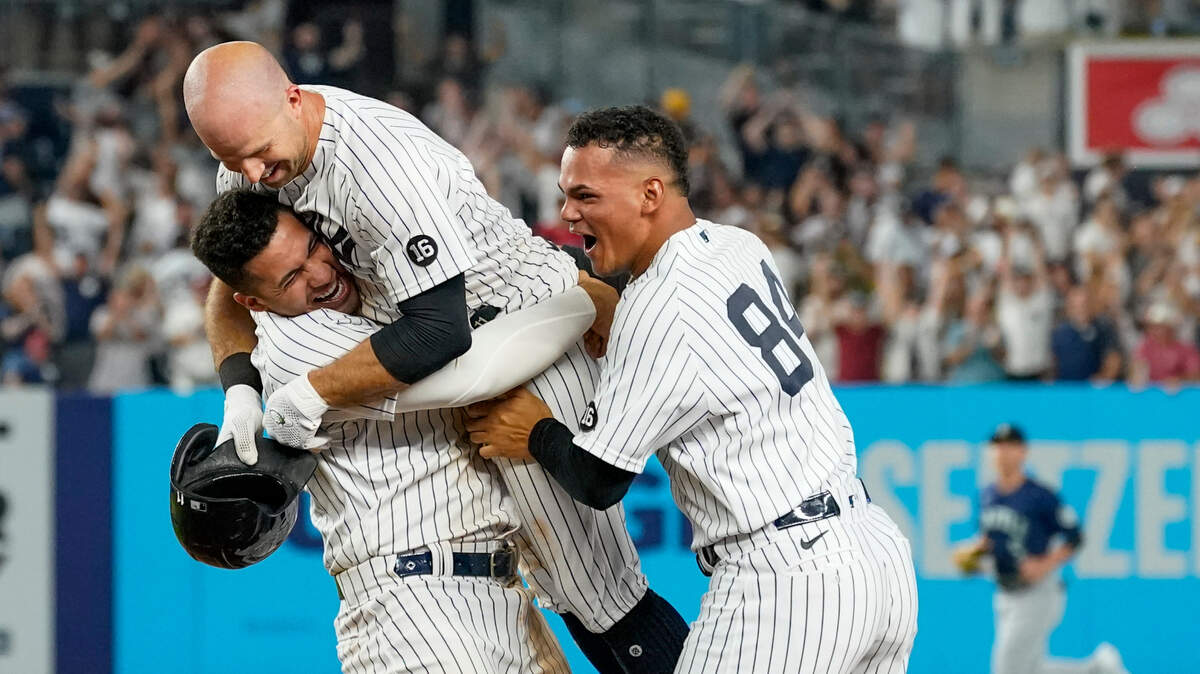 New York Yankees’ Brett Gardner, center, celebrates his walkoff winning an RBI-single with Albert Abreu (84) and Gleyber Torres in the 11th inning of a baseball game against the Seattle Mariners, Friday, Aug. 6, 2021, in New York. (AP Photo/Mary Altaffer)