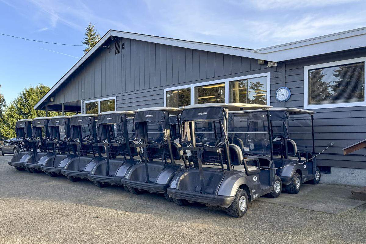 Rows of golf carts near the entrance of Madrona Links Golf Course on Wednesday, Feb. 12, 2025, near Gig Harbor, Wash.