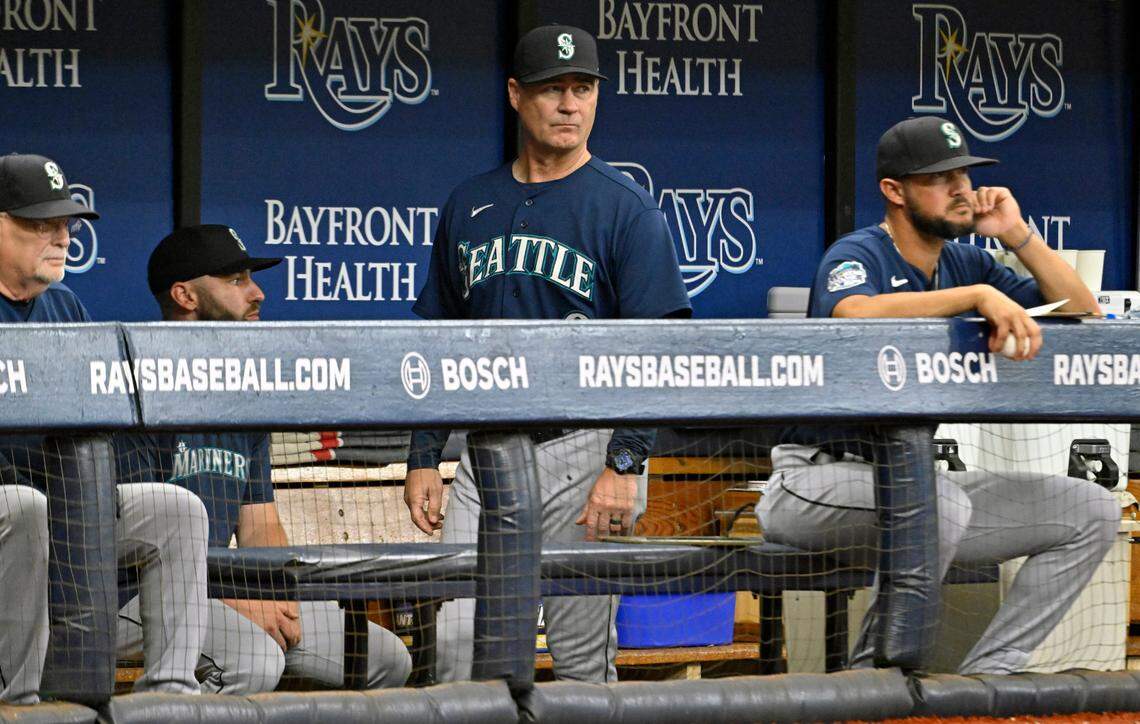 Seattle Mariners manager Scott Servais, center, walks in the dugout during the fifth inning of a baseball game against the Tampa Bay Rays, Sunday, Sept. 10, 2023, in St. Petersburg, Fla. (AP Photo/Steve Nesius)