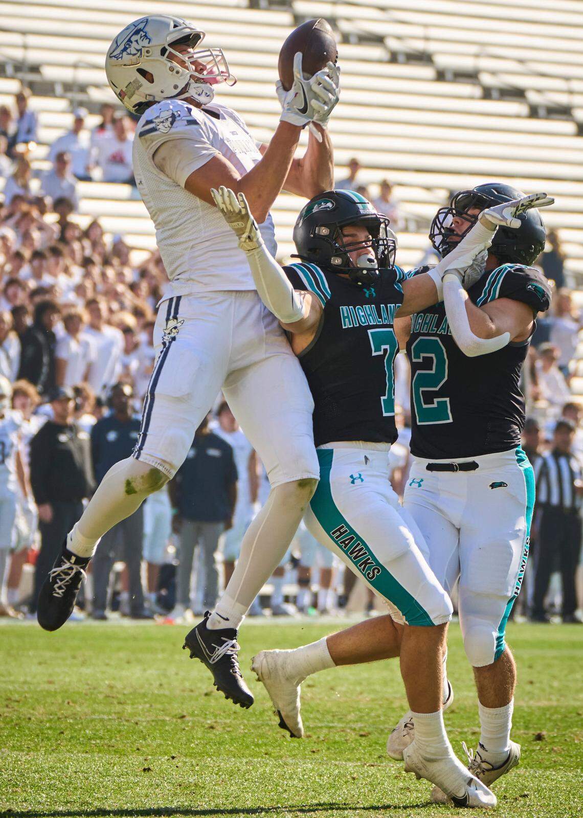Pinnacle Pioneers wide receiver Duce Robinson (2) catches the ball as Highland Hawks free safeties Cole Crandall (7) and Joseph Allen (2) put him under pressure during the 6A state championship game at Sun Devil Stadium in Tempe, Ariz. on Saturday, Dec. 10, 2022.