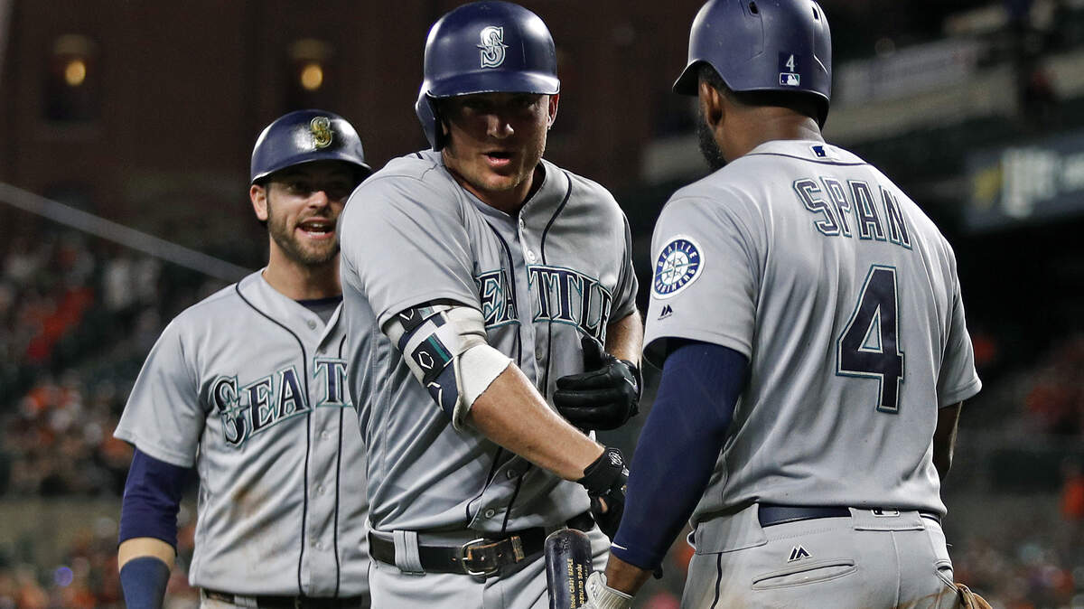 Seattle Mariners' Kyle Seager, center, and Mitch Haniger, back left, are greeted by Denard Span after Seager drove in Haniger with a home run in the ninth inning of a baseball game against the Baltimore Orioles, Wednesday, June 27, 2018, in Baltimore. Seattle won 8-7 in 11 innings. (AP Photo/Patrick Semansky)