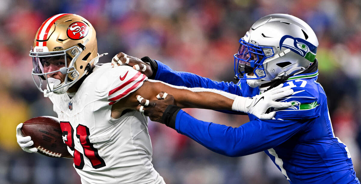 San Francisco 49ers running back Isaac Guerendo (31) stiff arms Seattle Seahawks linebacker Jerome Baker (17) as he tries to grab him during the third quarter of the game at Lumen Field, on Thursday, Oct. 10, 2024, in Seattle, Wash.