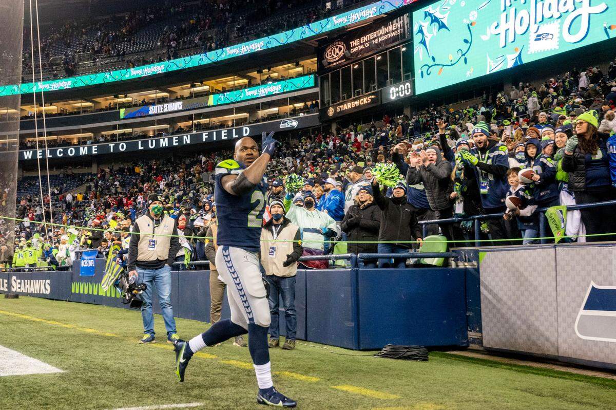 Seattle running back Adrian Peterson (21) waves to the fans as he walks off the field after the Seahawks beat San Francisco 49ers, 30-23 in an NFL game on Sunday at Lumen Field in Seattle.