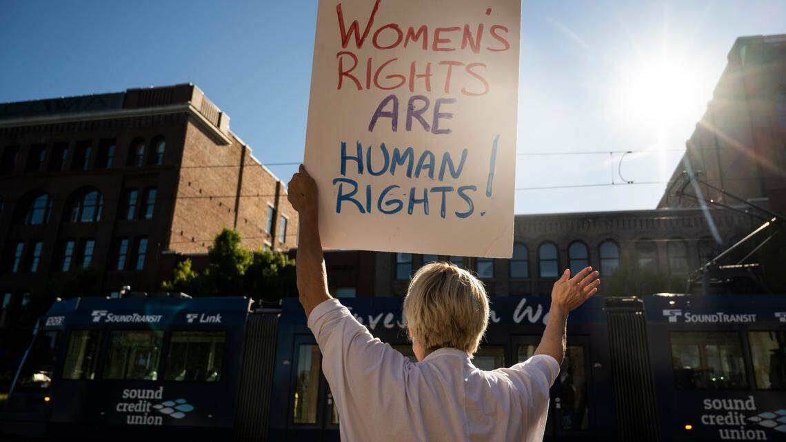 A protester holds a sign in the air as they rally against the U.S. Supreme Court’s ruling that overturned Roe v. Wade and abortion rights, outside of the U.S. District Courthouse in downtown Tacoma, Washington on Friday, June 24, 2022. A new study released by WalletHub ranking which states were best for women took reproductive rights into account.