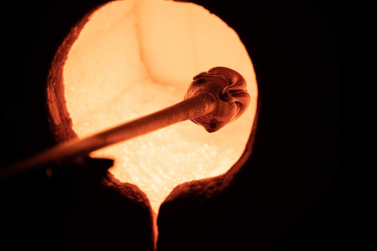 An artist creates a glass float for Monkeyshines 2022.