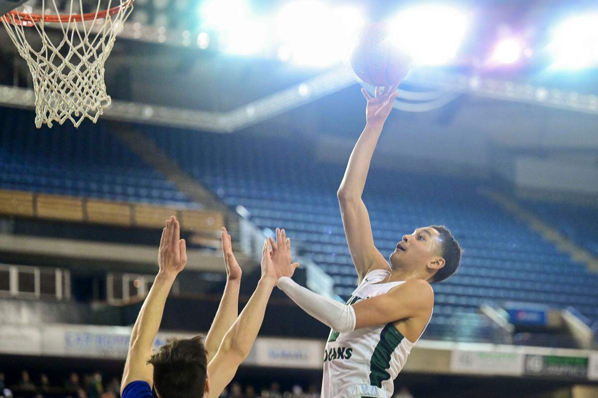 Auburn guard Trevon Blassingame (2) attempts a shot over a Seattle Prep defender during the second quarter of a Class 3A semifinal state tournament game on Friday, March 4, 2022, at the Tacoma Dome, in Tacoma, Wash.
