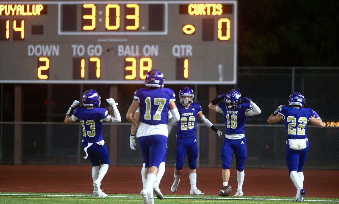 Puyallup defensive back Jacek Garden (10) and his Viking teammates celebrate his 62-yard pick six touchdown during Friday night’s football game at Sparks Stadium in Puyallup, Washington, Oct. 25, 2024. Puyallup won the game, 49-35.