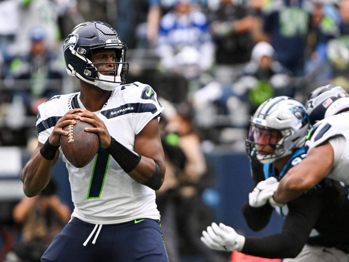 Seattle Seahawks quarterback Geno Smith (7) drops back to pass under pressure from Carolina Panthers defense during the second quarter of the game at Lumen Field, Sunday, Sept. 24, 2023, Seattle, Wash.