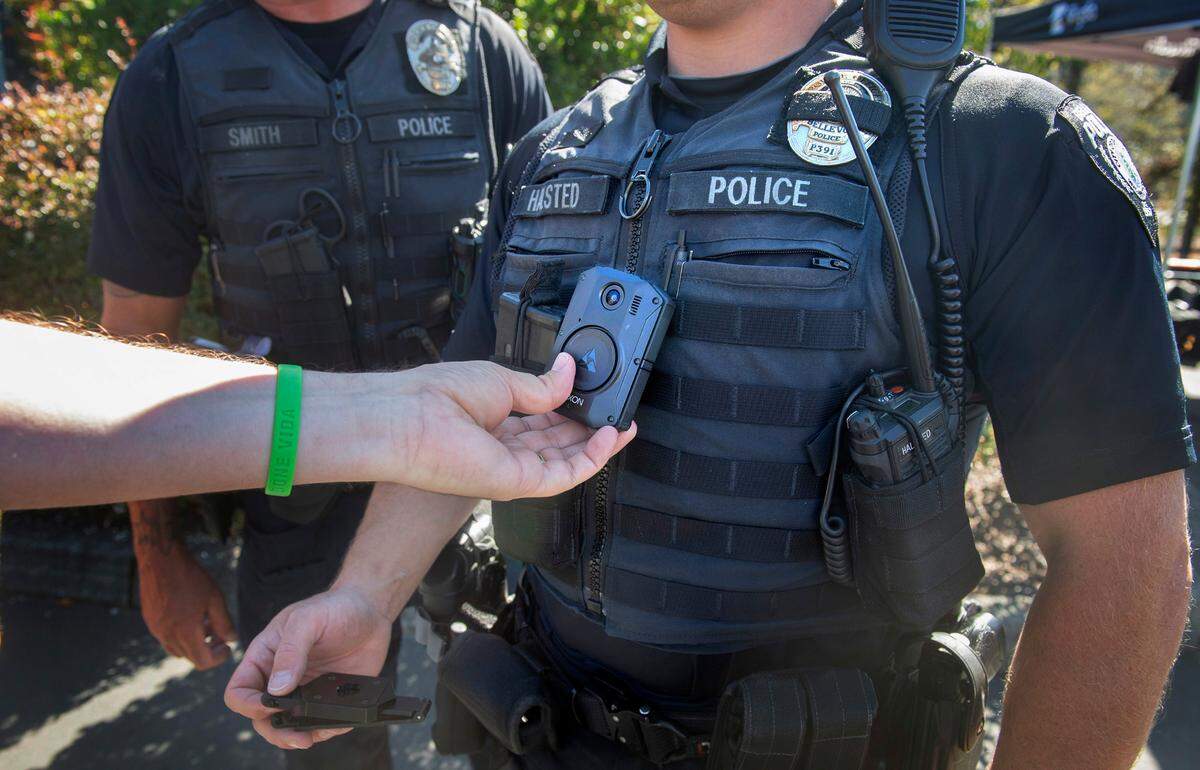 Police officers from around Western Washington get demonstrations of police body cameras during a technology fair at the Tacoma Police Department on Aug. 11, 2021.