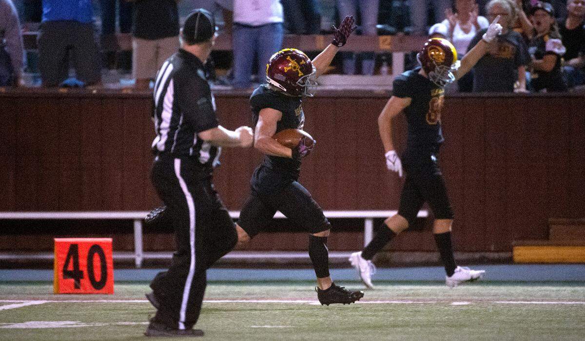 Enumclaw running back Dylan Watterson raises his hand after beating the last defender en route to an 87-yard game-winning touchdown run during Thursday night’s non-league football game against the Lakes Lancers at Enumclaw Stadium at Pete’s Pool in Enumclaw, Washington, Sept. 9, 2021.