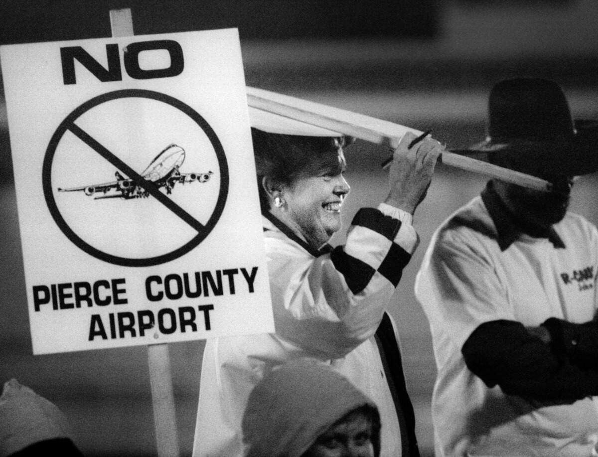 Barbara Skinner listens to citizens speak out against moving an airport to the area at Bethel High School on Oct. 19, 1994.
