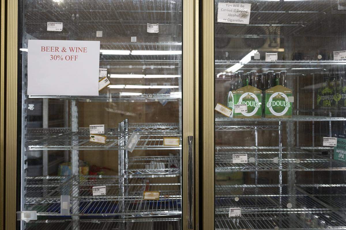 Shelves of beer are largely cleared out on closing day for Anderson Island General Store on Monday, Feb. 2, 2026, in Anderson Island, Wash.