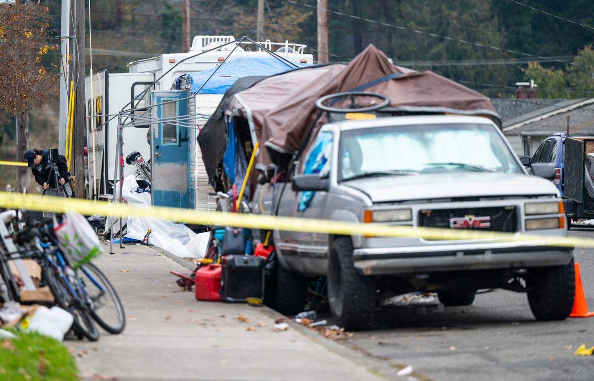 Crime scene technicians and Tacoma Police Department officers investigate a crime scene where two men were found dead with gunshot wounds near the 8000 block of South Hosmer Street in Tacoma, Wash. on Nov. 21, 2022.