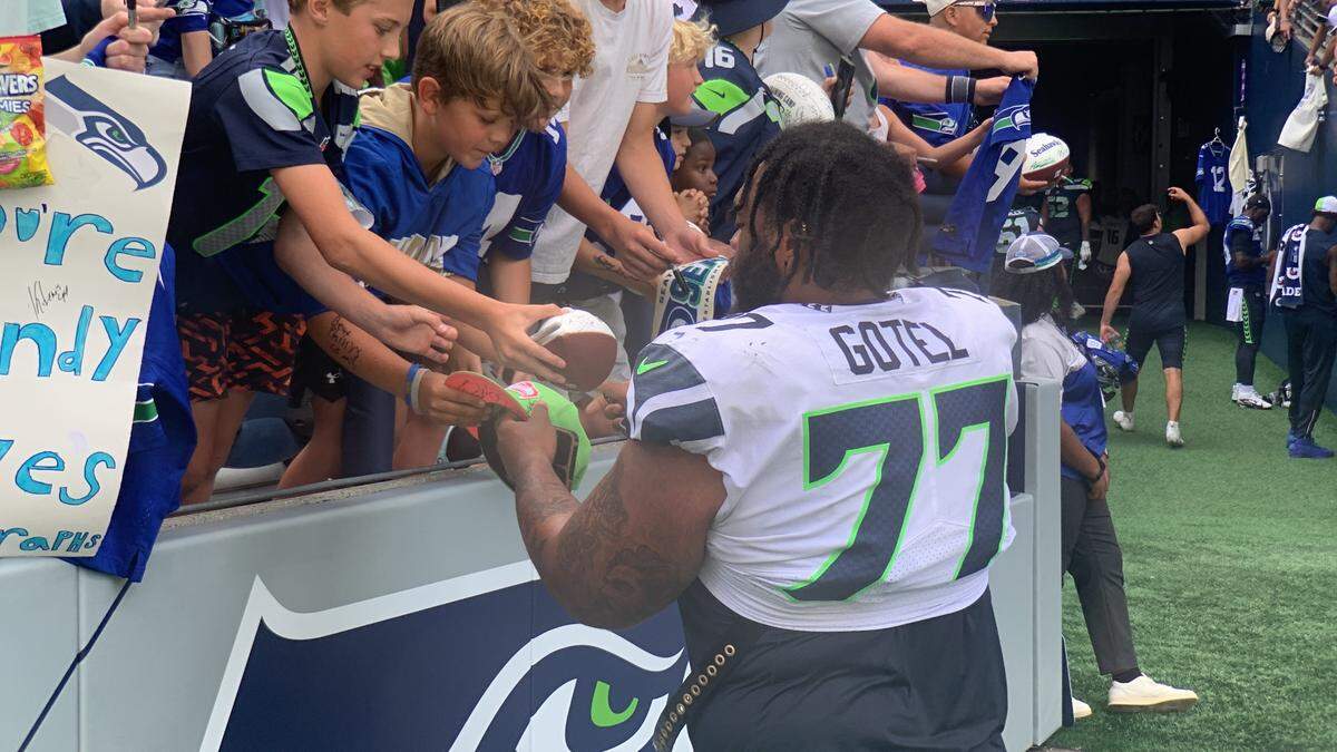 Tacoma native Matt Gotel, a defensive tackle from Lakes High School and the University of West Florida, signs autographs for fans at Lumen Field during the 10th practice of Seahawks training camp, Saturday, Aug. 3, 2024.