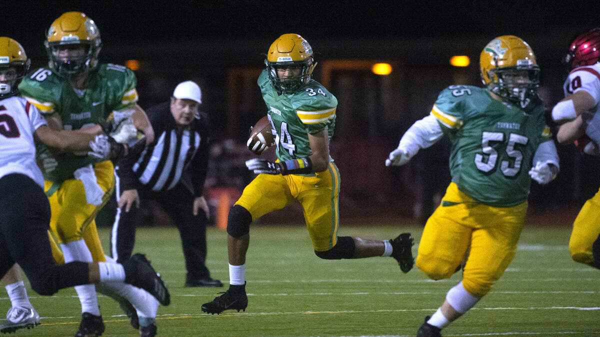 Tumwater running back Jaylen Clay follows blockers Hunter Baker (16) and Max Henry during Friday night’s opening round game of the 2A state football playoffs against Franklin Pierce at Tumwater District Stadium on Nov. 15, 2019.