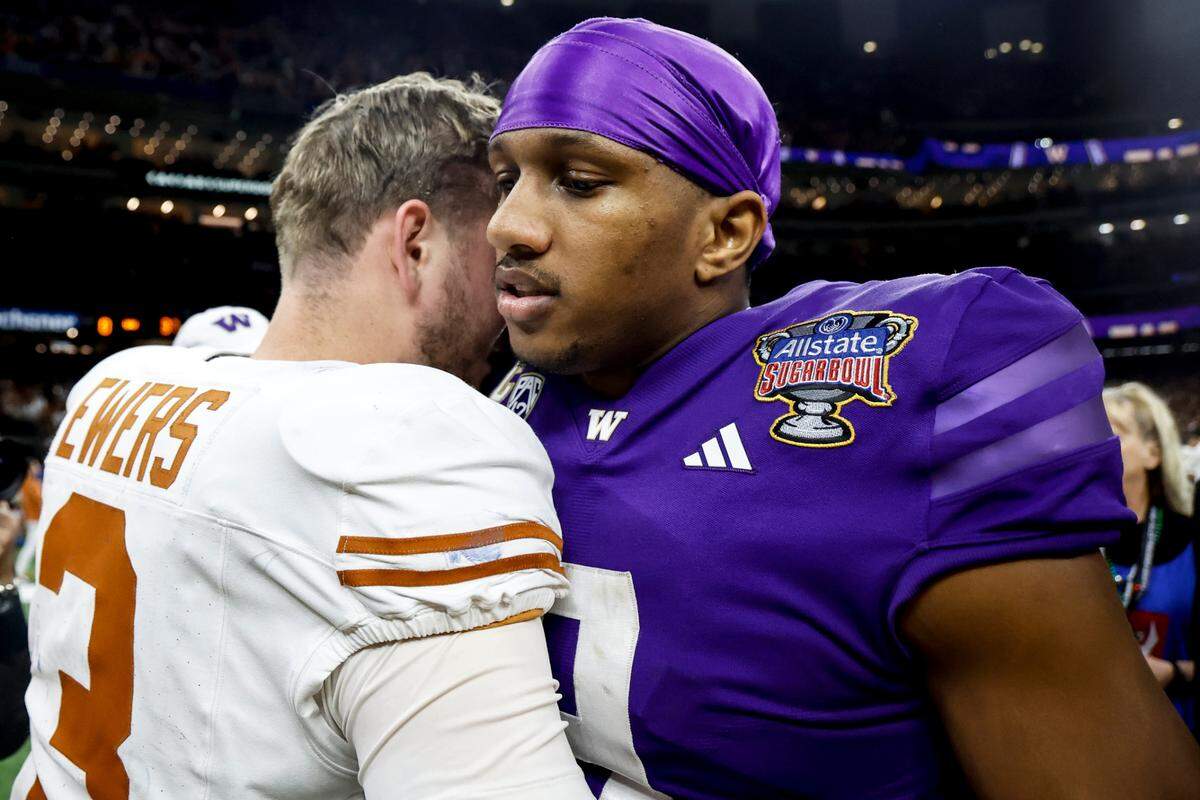Texas quarterback Quinn Ewers (3) and Washington quarterback Michael Penix Jr. (9) speak midfield after the Sugar Bowl CFP NCAA semifinal college football game between Washington and Texas, Monday, Jan. 1, 2024, in New Orleans. Washington won 37-31. (AP Photo/Butch Dill)