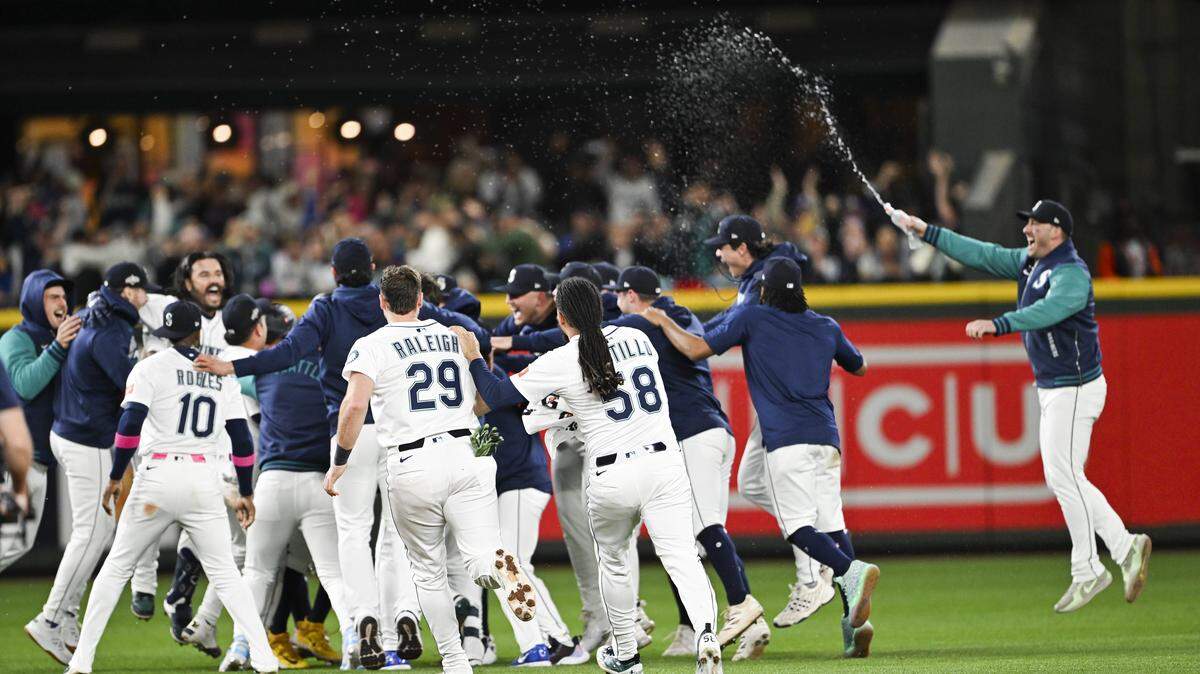 The Seattle Mariners celebrate their 3-2 win in Game 5 of the AL Division Series against the Detroit Tigers at T-Mobile Park, on Friday, Oct. 10, 2025, in Seattle.