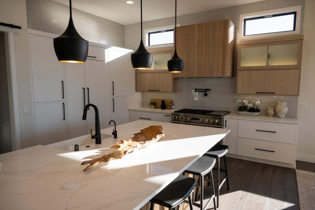 The kitchen is packed with features like a “dirty kitchen”, wine cooler, and Tambour accents above the hood, in this home on the market from Rush Residential, on Wednesday, Jan. 29, 2025, in Tacoma.