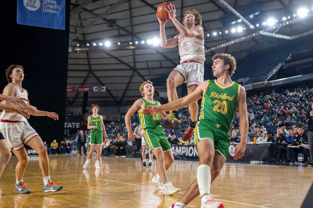Mount Si guard Trevor Hennig (4) drives to the basket for a layup as Richland guard Josh Woodard (12) and guard Jase Vopalensky (20) look on during the third quarter of a Class 4A quarterfinal game on Thursday, March 2, 2023, in Tacoma, Wash.