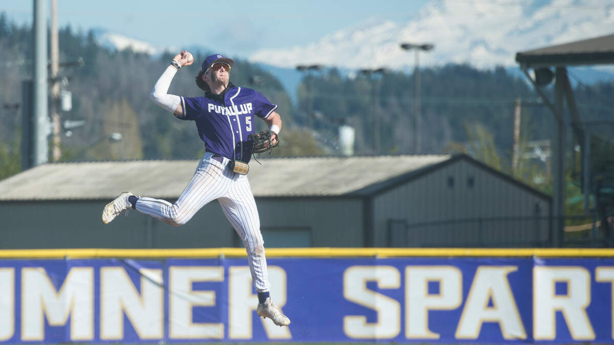 Puyallup shortstop Gage Thompson makes a leaping throw to first base after fielding a ground ball in a Class 4A South Puget Sound League baseball game against Sumner on Tuesday, April 25, 2023 at Sumner High School in Sumner, Wash.