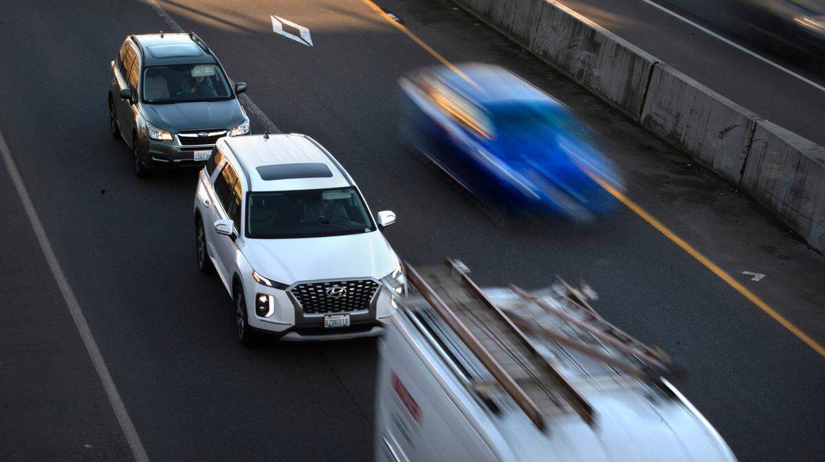 A car uses the non-metered HOV lane to pass a line of vehicles waiting at the on-ramp light at 54th Avenue to southbound Interstate 5 through Fife, Washington, on Tuesday, March 5, 2024. Washington State Patrol Trooper Shannon McKenzie says the number one complaint they receive from the public is about HOV lane violators.
