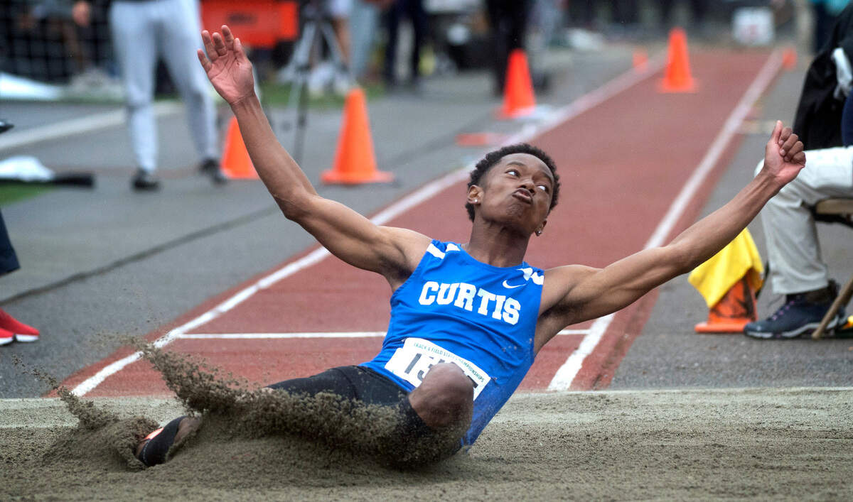 Curtis’ Titus Morris splashes down for a state championship in the 4A boys long jump competition during the final day of the WIAA State Track and Field Championships at Mount Tahoma High School in Tacoma, Washington on Saturday, May 28, 2022.