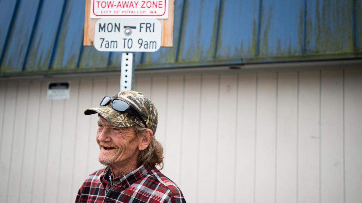 Micheal Boggs stands near the space where he would park his truck while living out of it in Puyallup. Boggs, who has since found housing, says that the cost of gas while living out of his vehicle was a big hindrance to getting himself into housing earlier. Photographed Oct. 1.