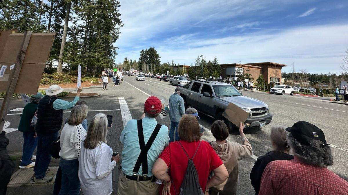 Residents protest policies led by Trump and Musk Saturday afternoon, April 5, 2025, in Gig Harbor, Wash. According to protester Loreto Tessicini, the event was organized as part of a nationwide movement called The 50501 Movement or Hands Off! and drew 400 to 500 people.