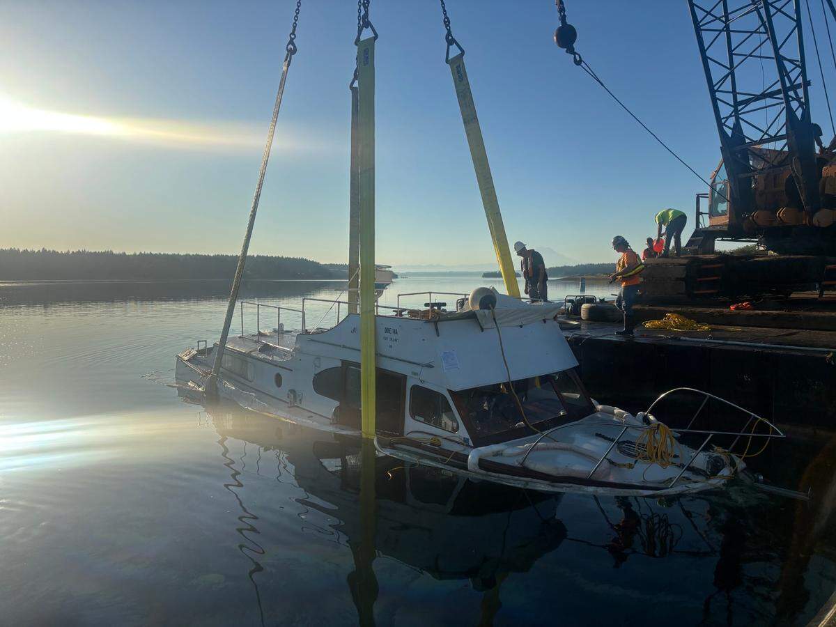 Contractors oversee the emergency removal of a vessel that was sinking in Filucy Bay on Wednesday, July 16, 2025, near Key Peninsula.