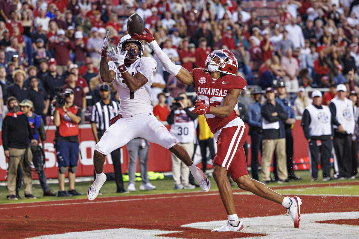 FAYETTEVILLE, ARKANSAS - OCTOBER 18: Julian Neal #23 of the Arkansas Razorbacks tips a pass in the end zone in the second half that was thrown to KC Concepcion #7 of the Texas A&M Aggies at Donald W. Reynolds Razorback Stadium on October 18, 2025 in Fayetteville, Arkansas. The Aggies defeated the Razorbacks 45-42. (Photo by Wesley Hitt/Getty Images)