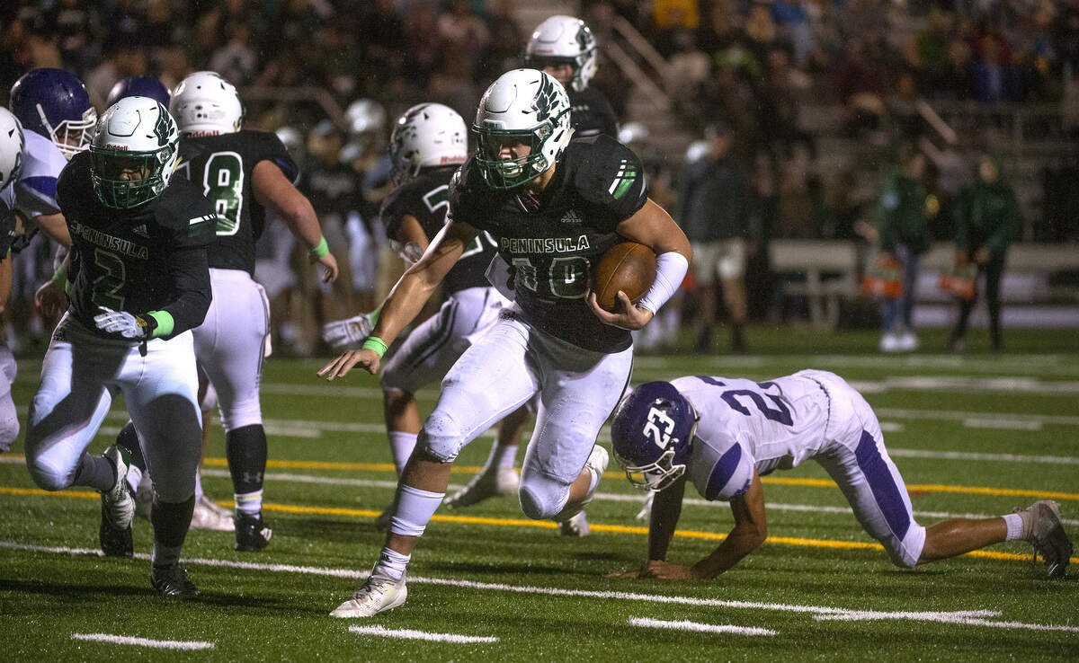 Peninsula running back Sean Sklandany carries the ball during Thursday night’s 3A SSC league opener football game against North Thurston at Roy Anderson Field in Gig Harbor on Sept. 19, 2019.