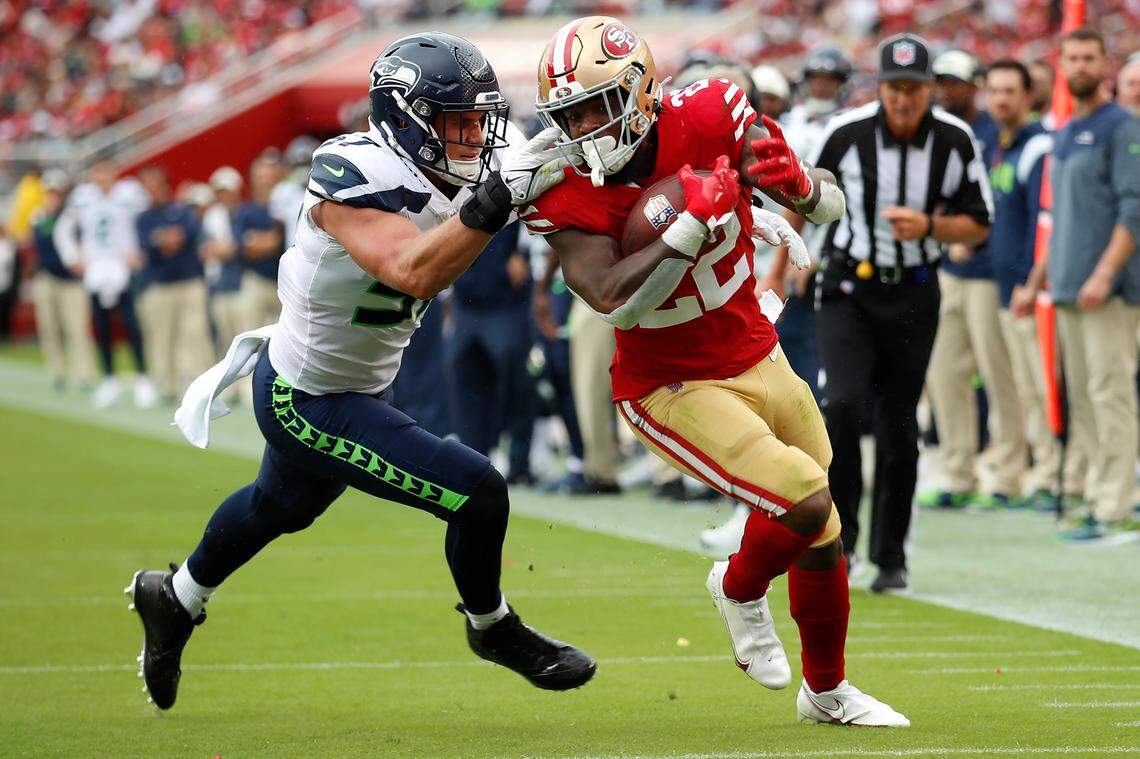 San Francisco 49ers running back Jeff Wilson Jr. (22) runs against Seattle Seahawks linebacker Cody Barton during the first half of an NFL football game in Santa Clara, Calif., Sunday, Sept. 18, 2022. (AP Photo/Josie Lepe)