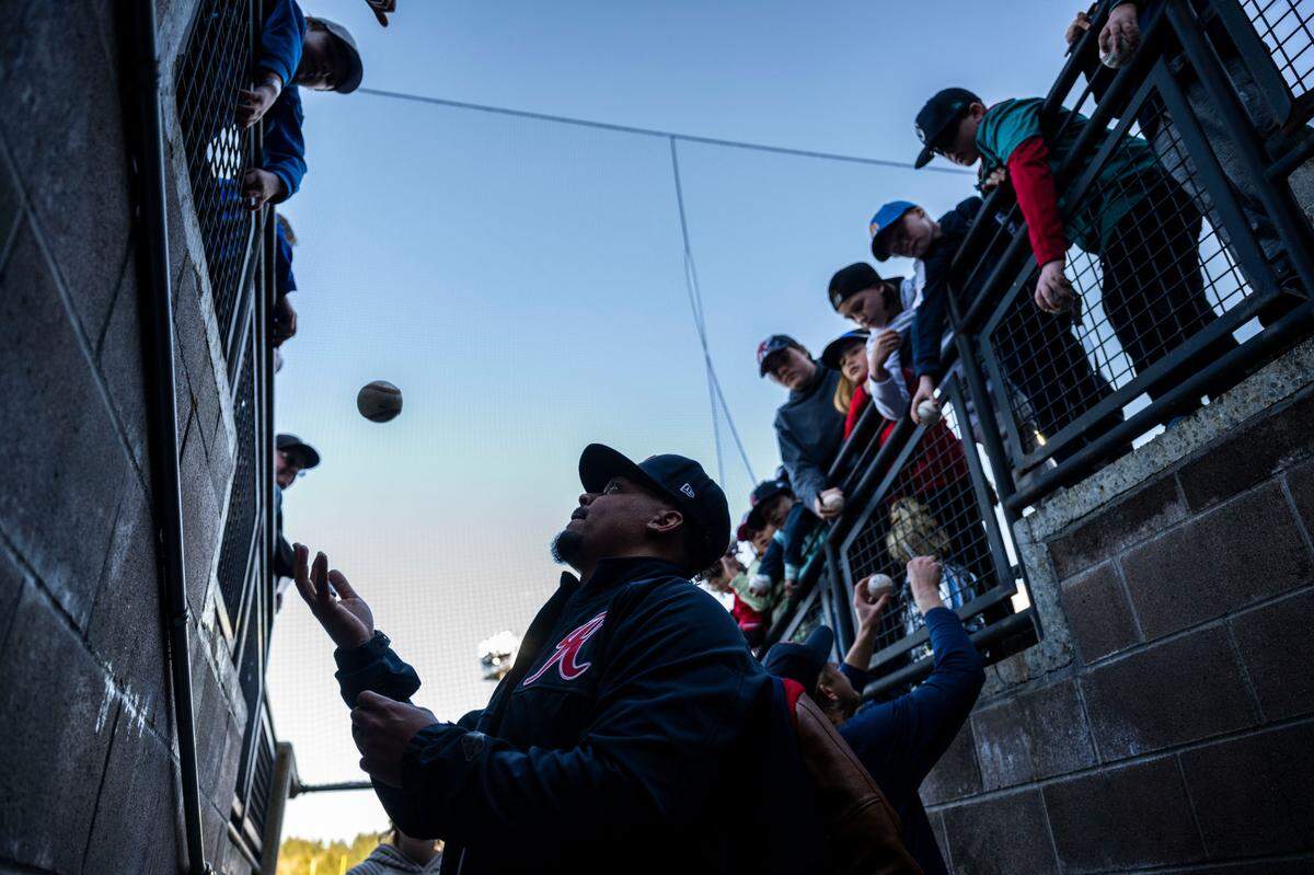 Tacoma Rainiers pitcher Justus Sheffield (15) signs fans balls before the start of the Rainiers home opener game against the Reno Aces at Cheney Stadium in Tacoma, Wash. on April 4, 2023. The Rainiers won 12-5.