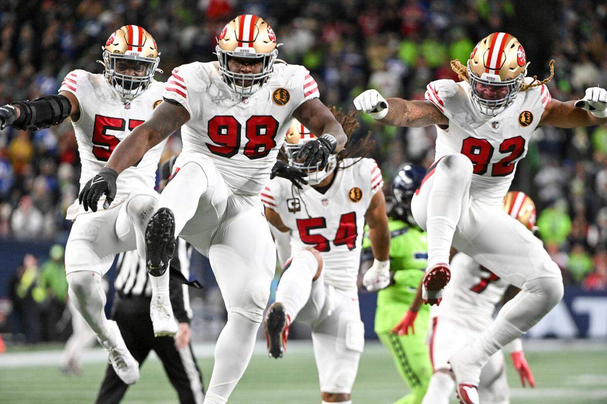San Francisco 49ers defensive tackle Javon Hargrave (98) celebrate a sack on Seattle Seahawks quarterback Geno Smith (7) during the second quarter of the game at Lumen Field, Thursday, Nov. 23, 2023, in Seattle, Wash.