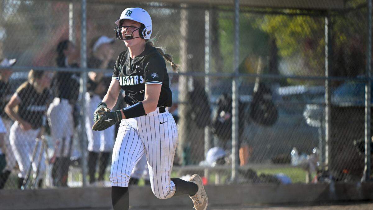 Emerald Ridge’s Ava Puttler (14) reacts to scoring a run during the softball game at Puyallup High School, on Friday, April 18, 2025, in Puyallup, Wash.