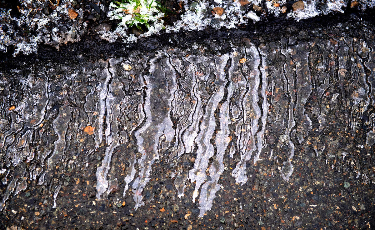 Ice lines the roadway on the the Center Drive off-ramp in DuPont, Washington, on Tuesday, Jan. 4, 2022.