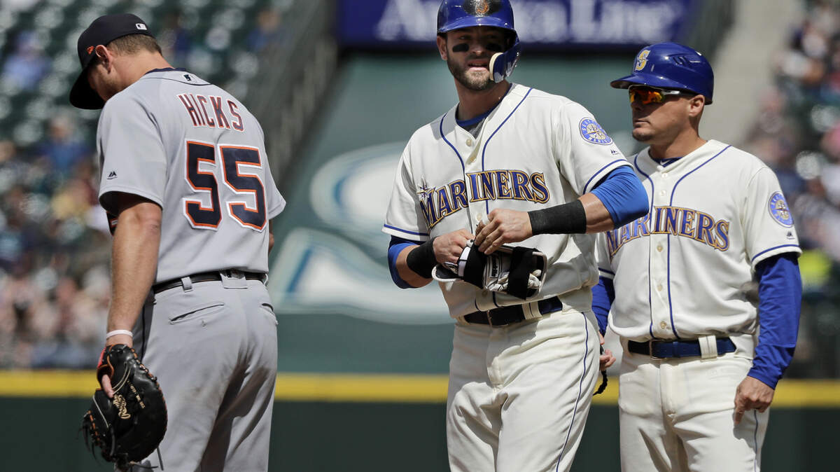 Seattle Mariners' Mitch Haniger, center, stands on first base next to Detroit Tigers first baseman John Hicks (55) and first base coach Chris Prieto, right, after hitting a single to break up a no-hitter in the seventh inning of a baseball game against the Detroit Tigers, Sunday, May 20, 2018, in Seattle. (AP Photo/Ted S. Warren)