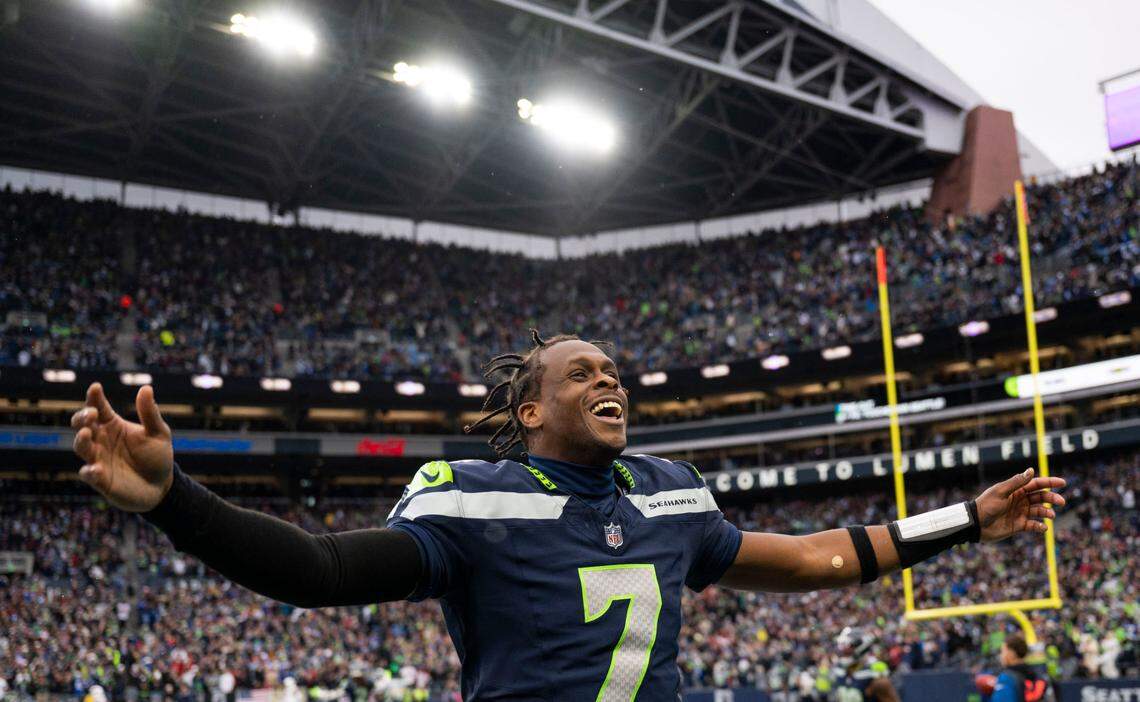 Seattle Seahawks quarterback Geno Smith (7) reacts to cornerback Coby Bryant (8) touchdown during the third quarter of the game against the Arizona Cardinals at Lumen Field, on Sunday, Nov. 24, 2024, in Seattle, Wash.