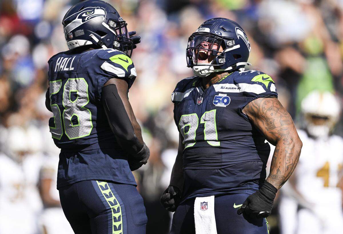 Seattle Seahawks defensive tackle Byron Murphy II (91) reacts to a hit on New Orleans Saints quarterback Spencer Rattler (2) during the third quarter of the game at Lumen Field, on Sunday, Sept. 21, 2025 in Seattle.