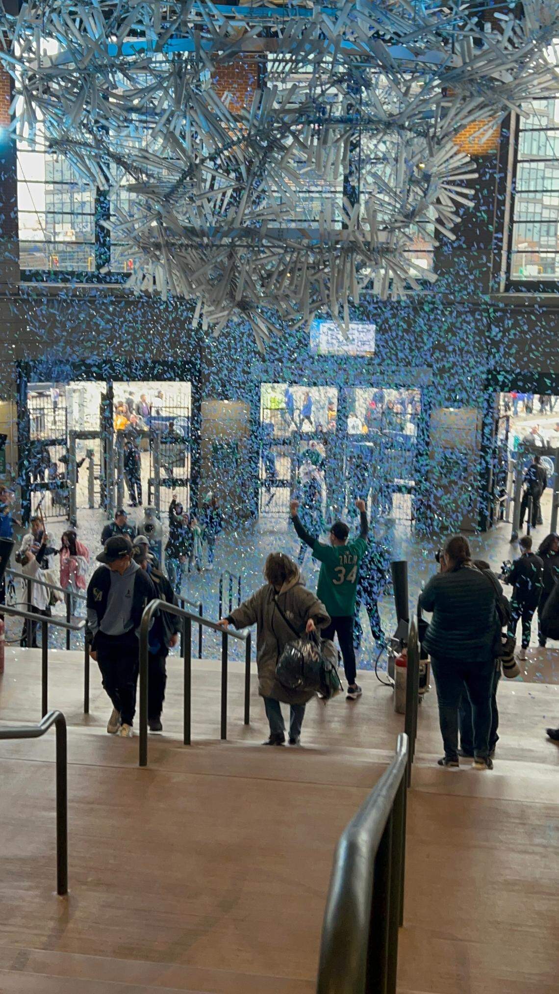 Fans stream in as the Home Plate Gates at T-Mobile Park open amid blue and green confetti two hours before first pitch of Mariners Opening Day vs. the Athletics March 27, 2025, in Seattle.