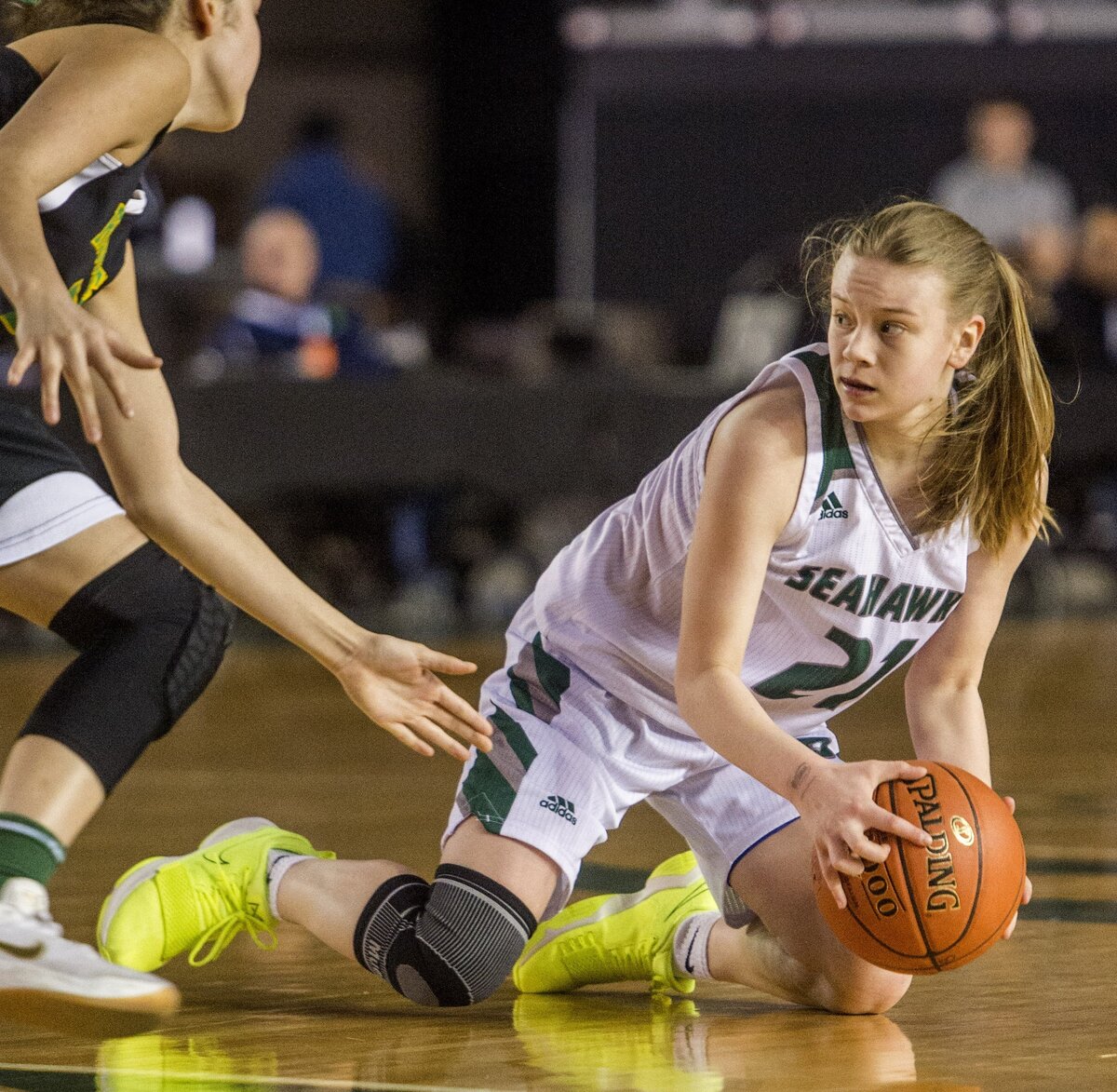 Piper Bauer of Peninsula High School looks to pass in an opening round game of the girls 3A basketball state championships held in the Tacoma Dome, February 27, 2019. Peninsula lost to Roosevelt 56-60.