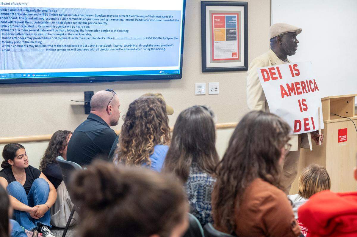 Alton McDonald, right, a Franklin Pierce School District parent, speaks during a public comment portion of a school board meeting on Tuesday, June 3, 2025, at the district’s administrative center. McDonald was one of roughly 30 people to speak that night, calling attention to issues like discrimination and budgetary cuts in the district.
